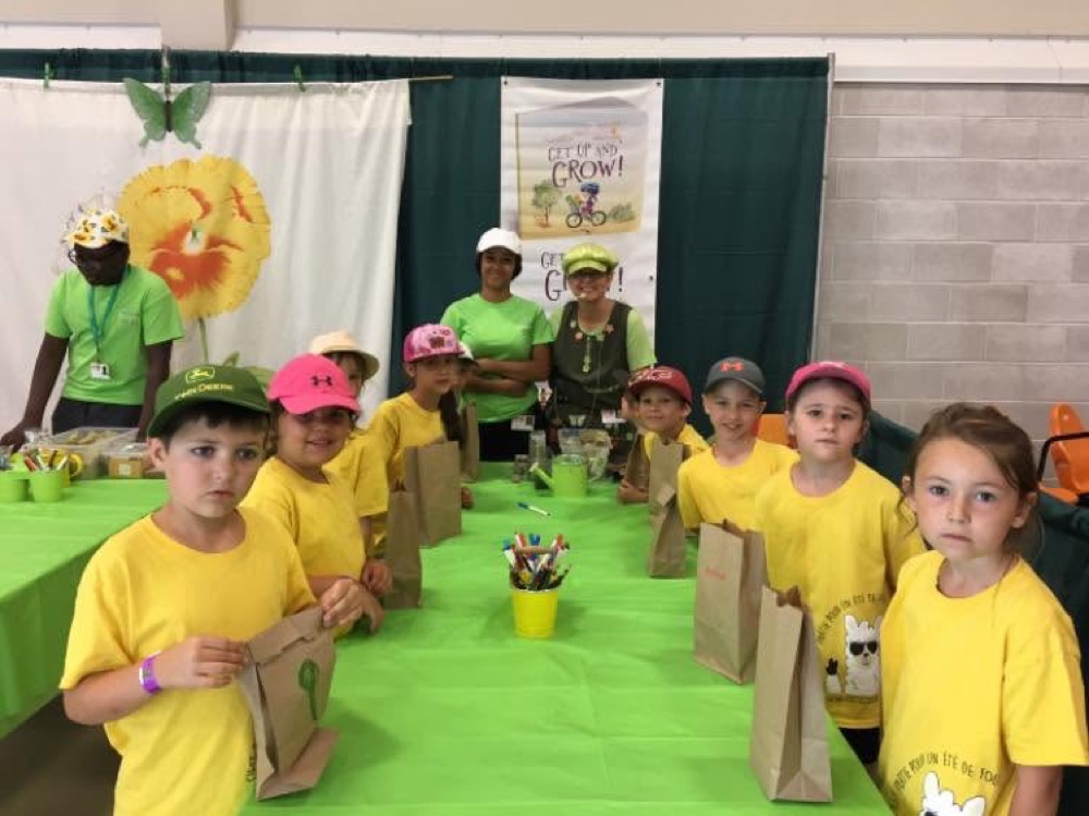 Elaine teaching a group of kids to plant seeds at a Get Up and Grow workshop
